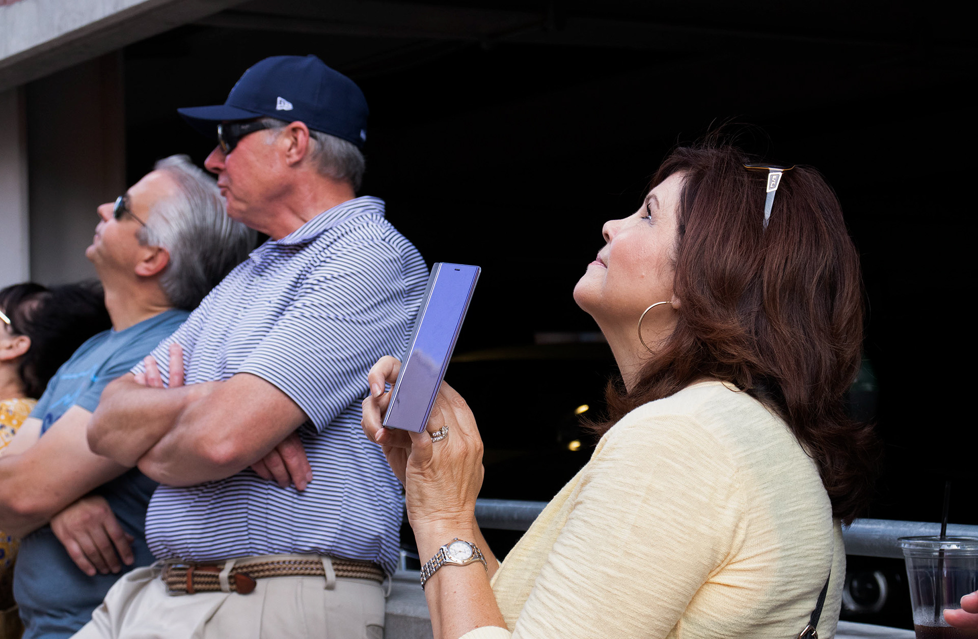 As volunteers rappelled down the hotel, many onlookers stopped to watch. This woman videoed as former MU Football Coach Gary Pinkel and KMIZ-17 News Anchor Joey Parker descended from the top together.