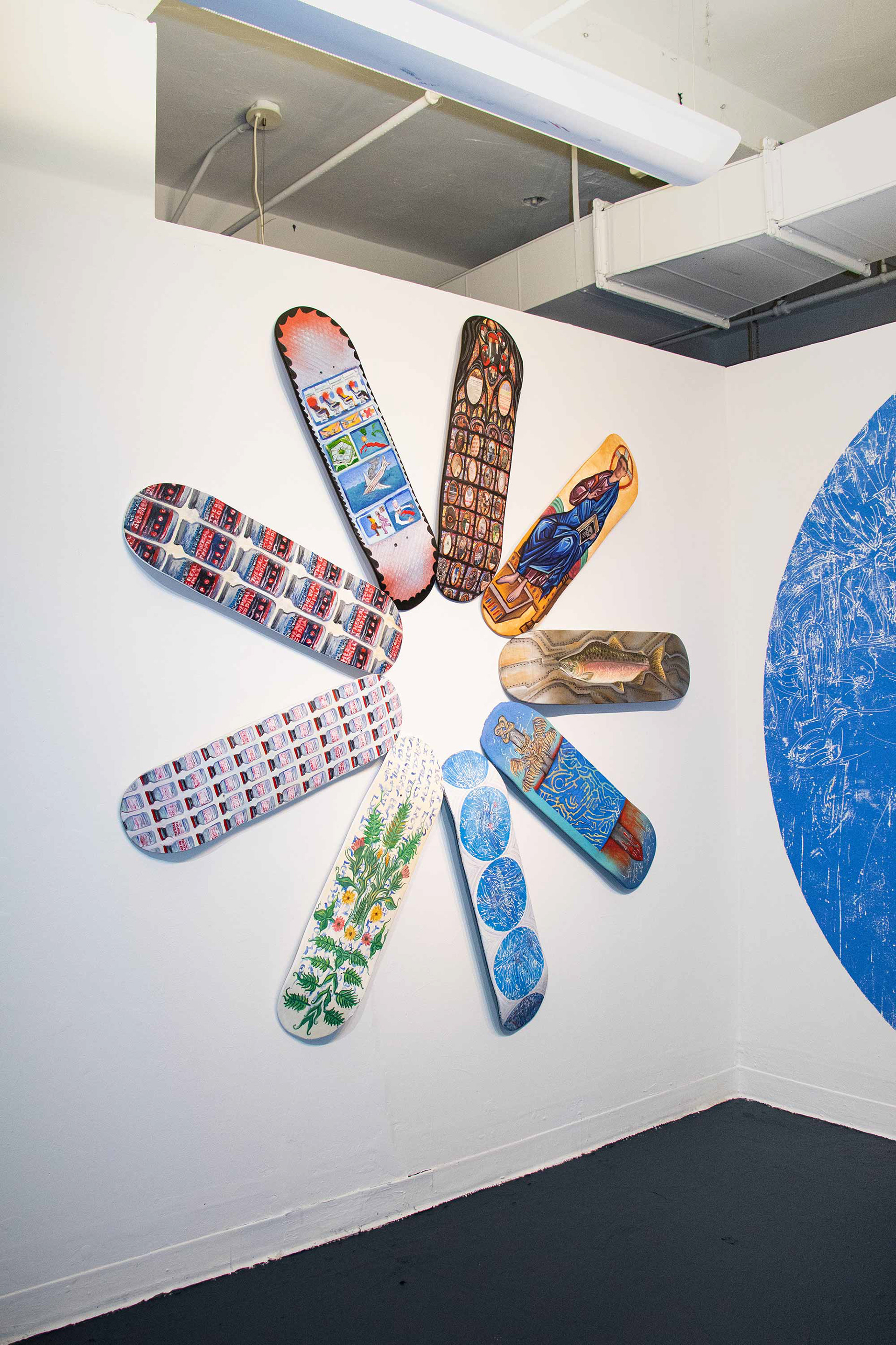 Wheel of Fortune. 2021. Oil and collage on (9) 32" x 8.5" wooden skateboard decks. 6' x 6'