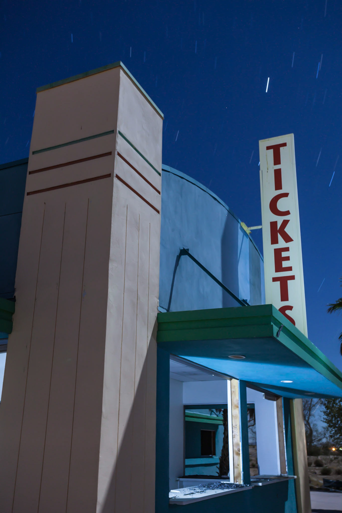 Night time photography of a ticket counter in an abandoned water park in the Mojave desert.