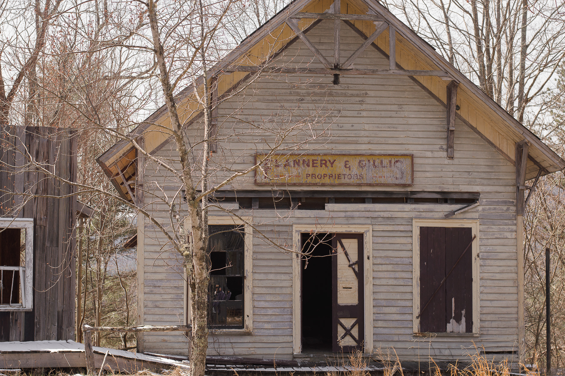 An abandoned business with the sign reading Flannery & Gills Proprietors
