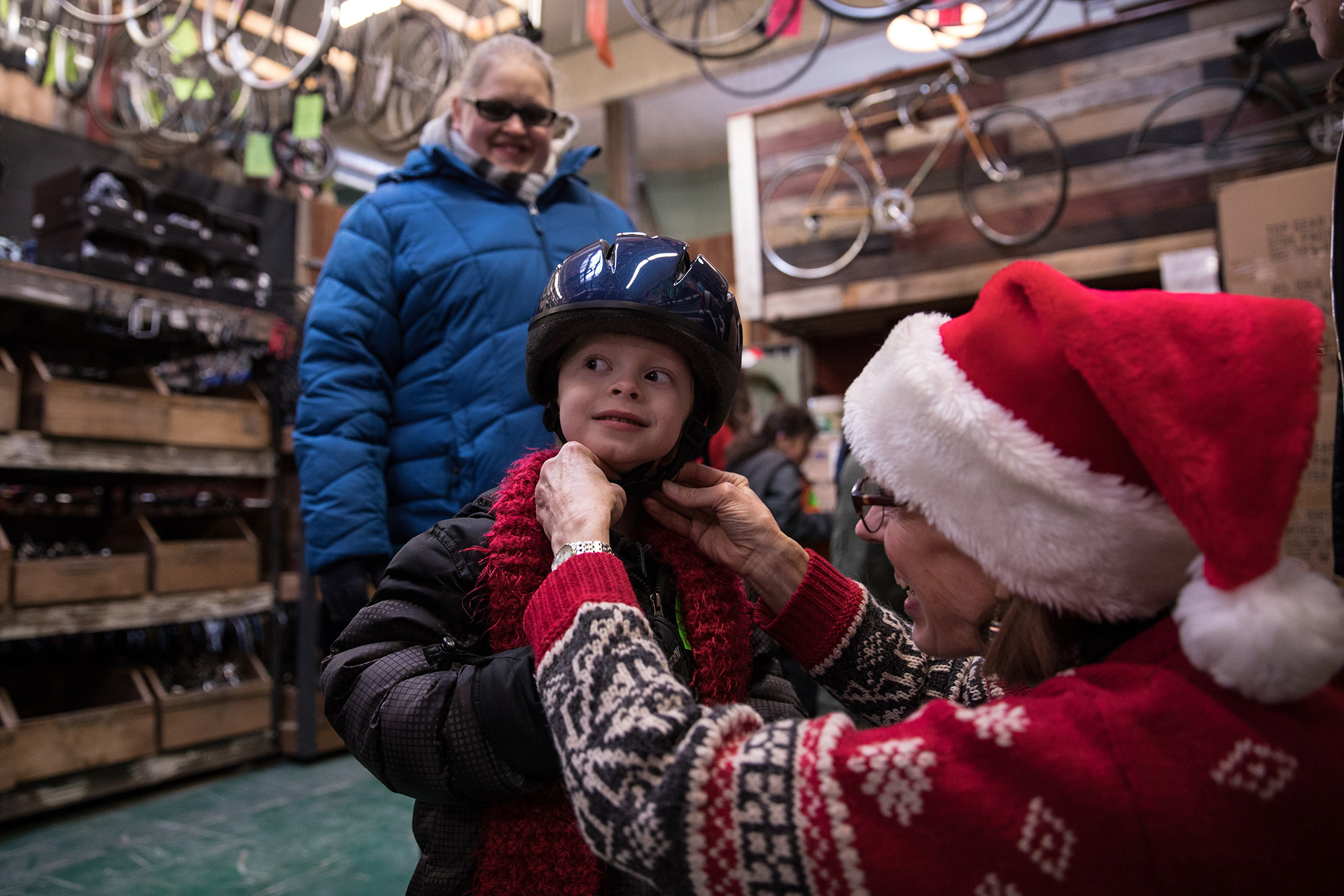 A child gets fitted for a helmet at the Boise Bicycle Project's annual Holiday Kid's Bike Giveaway where low-income children can receive a bike and safety gear for free on Dec. 15 in Boise.
