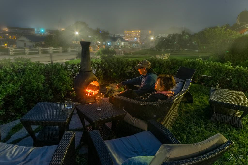 Foggy night, people enjoying fire at Island House, Mackinac Island