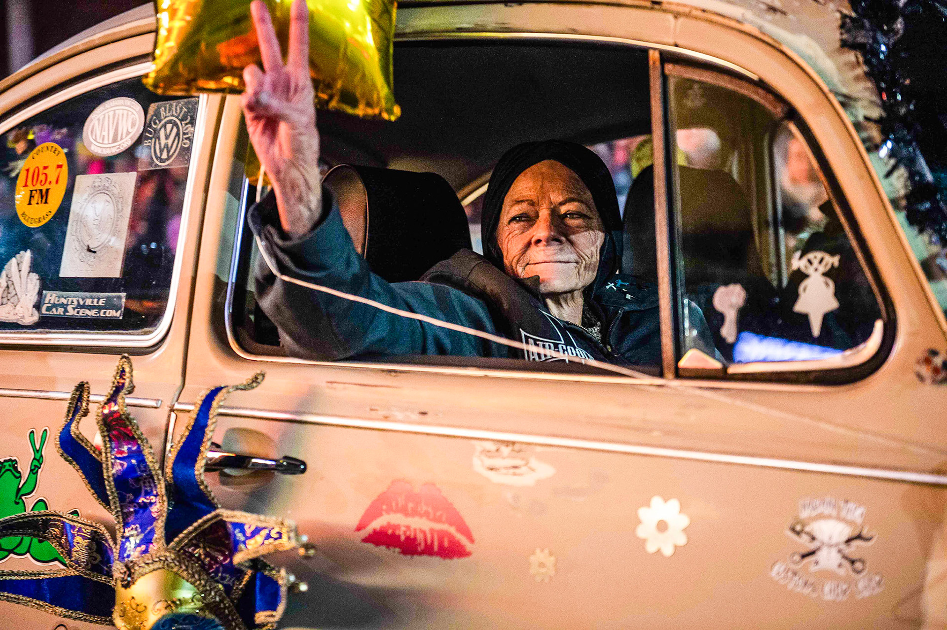 Shelia Nix holds out a peace sign to the crowd during the Carnegie Carnival Parade on Saturday, March 2, 2019, in downtown Decatur, Ala.