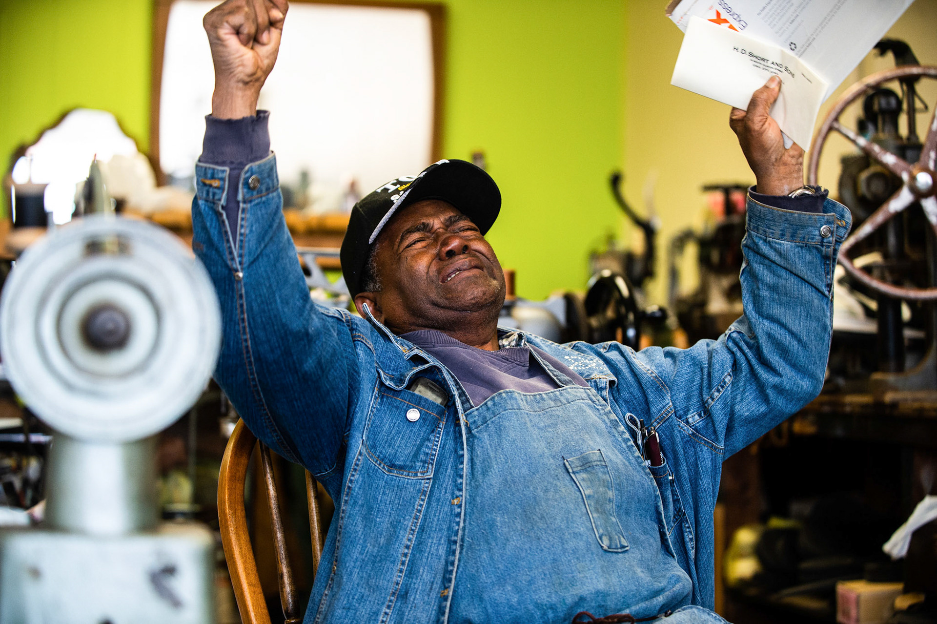 Jim Blackburn, 82, of Decatur Shoe Repair reacts at his business after receiving a check for $5,000 to replace machinery that was stolen from him, Thursday, December 6, 2018, in Decatur, Ala.
