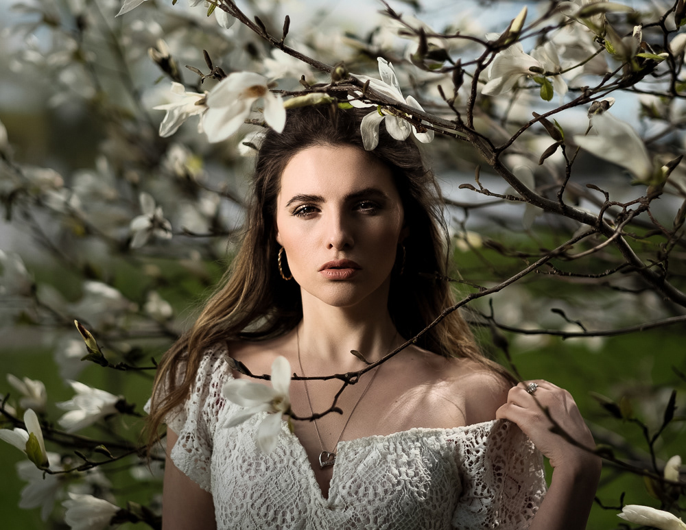 Beauty portrait near magnolia tree