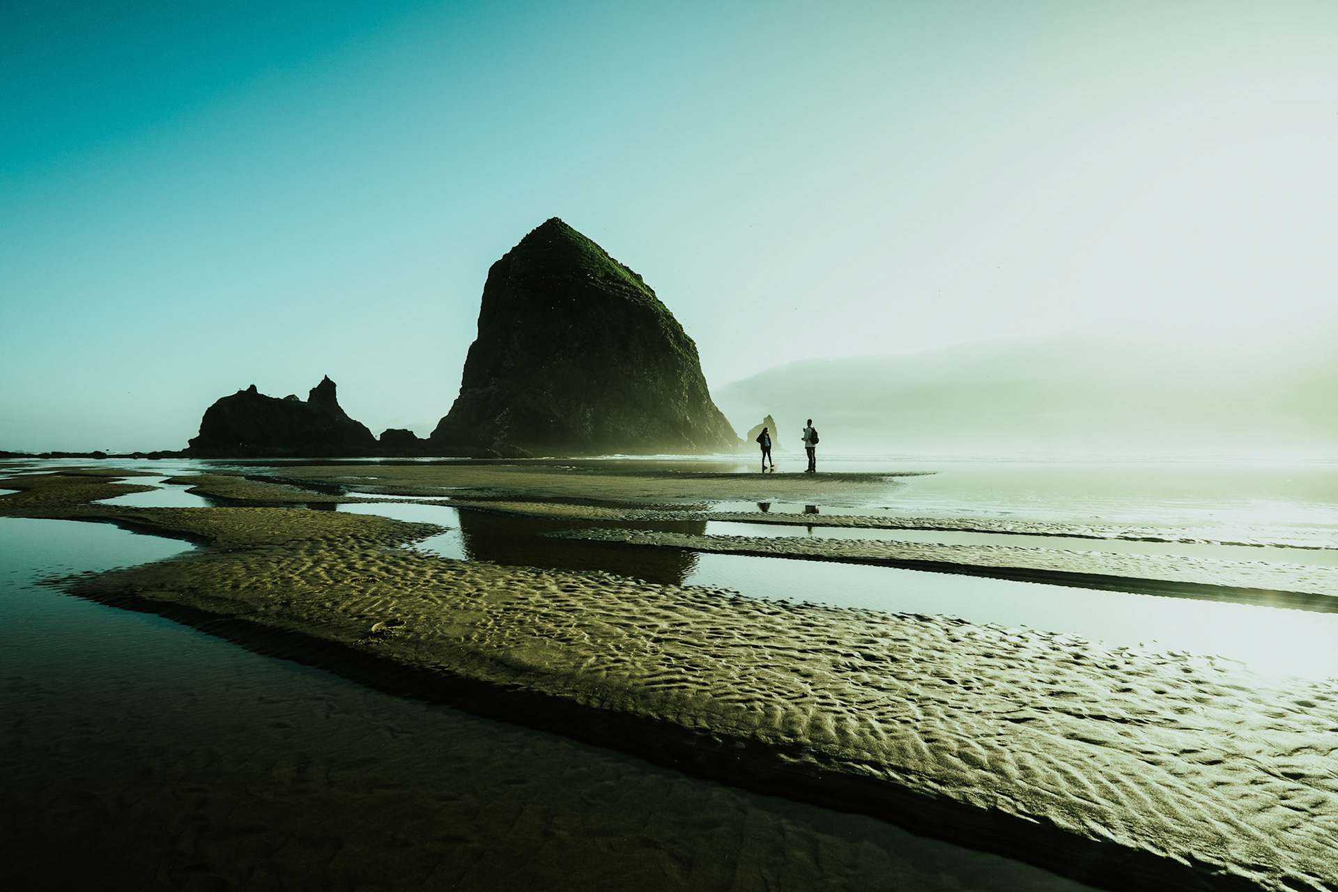 Cannon Beach is a small coastal city in northwest Oregon. It’s known for its long, sandy shore. Standing tall in the ocean, Haystack Rock is a seasonal haven for tufted puffins. Oregon. USA