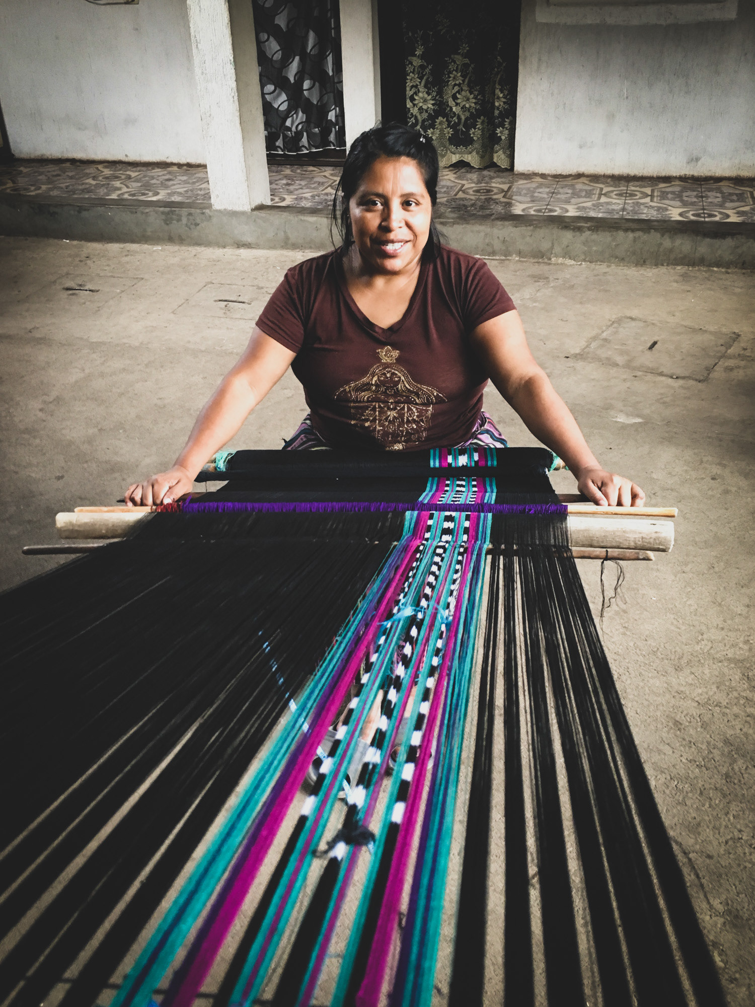 Susana weaving the poncho design