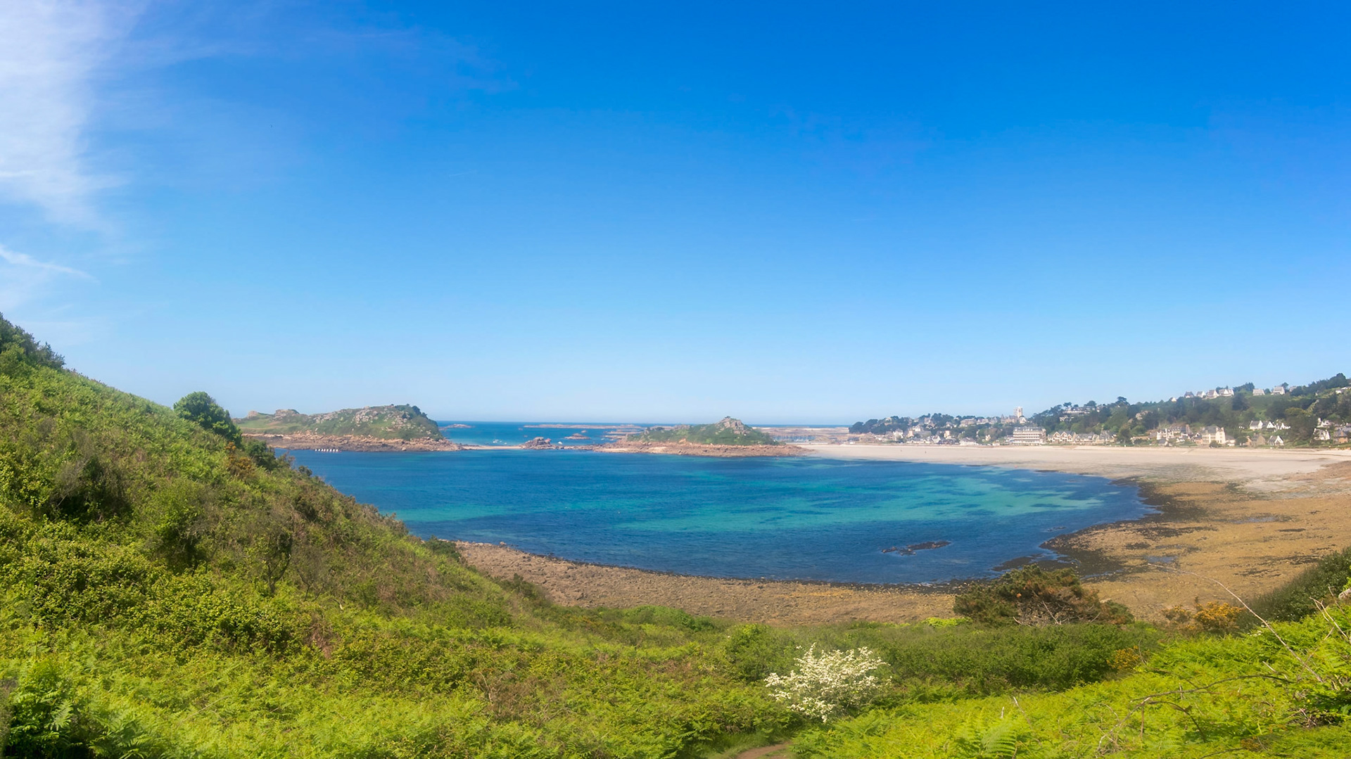 The bay of Trébeurden seen from Pointe de Bihit. Wonderful blue ocean, a line of small sailing boats, vacation!