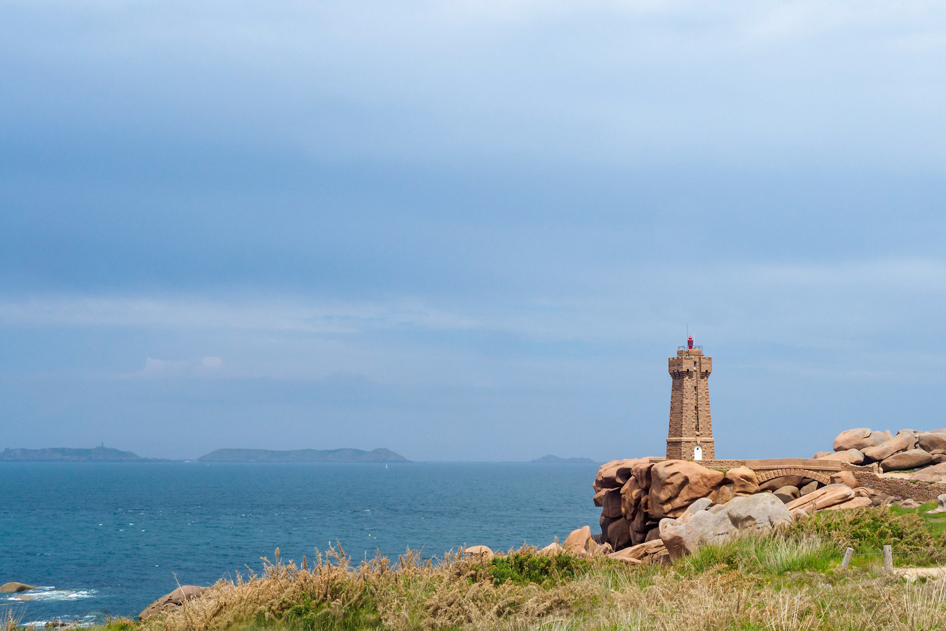 The Light House Mean Ruz in Bretagne; France, under a clouded sky, overlooking the English channel towards the famous seven islands. A glorious view any day!