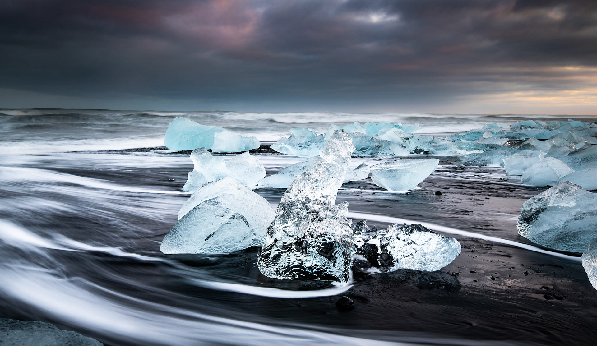 Diamond beach is one of the most impressive place in Iceland. Here, the ice on top of the volcanic sand captured in the sunset time just before the storm hits to the shore.